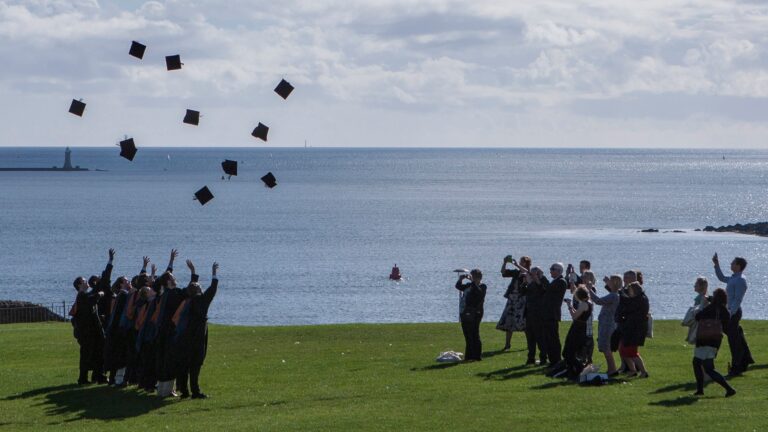 Graduates celebrate obtaining their degree certificate.